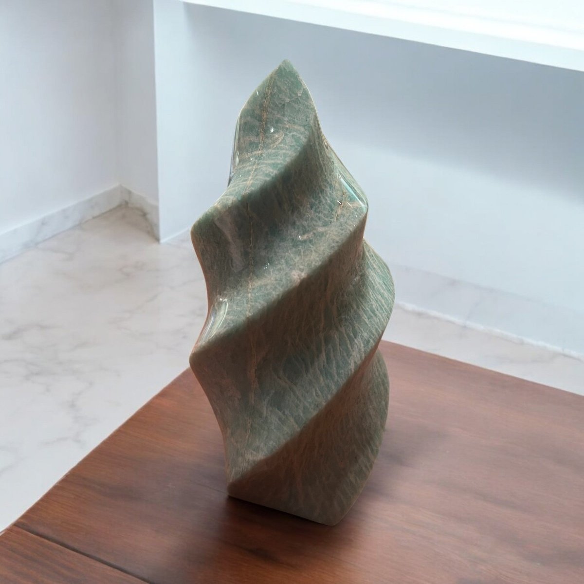 A beautifully polished palm stone, comfortably shaped for easy holding, displaying calming colours and patterns that promote relaxation and emotional balance