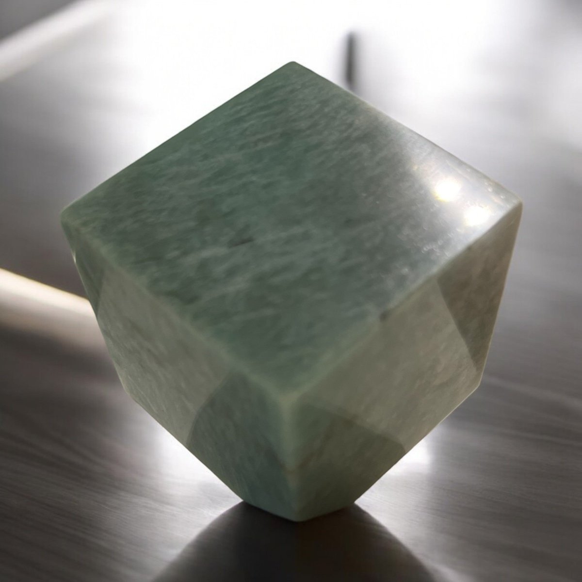 polished Amazonite cube, exhibiting vibrant blue-green hues and smooth surfaces, symbolizing stability and grounding energy while enhancing your meditation and healing practices