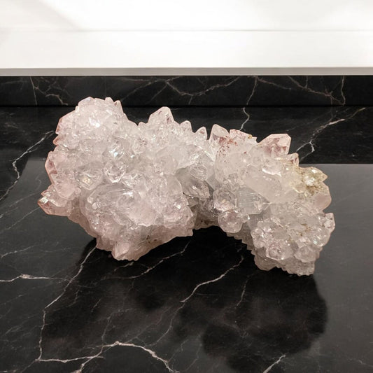 Apophyllite crystal cluster showcasing its transparent and greenish hues, symbolizing clarity and spiritual connection