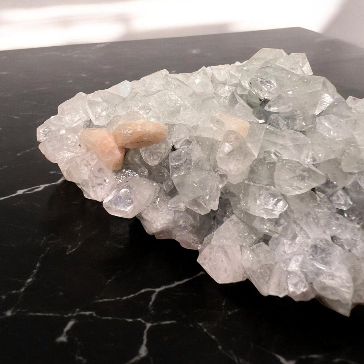 Apophyllite crystal cluster showcasing its transparent and greenish hues, symbolizing clarity and spiritual connection